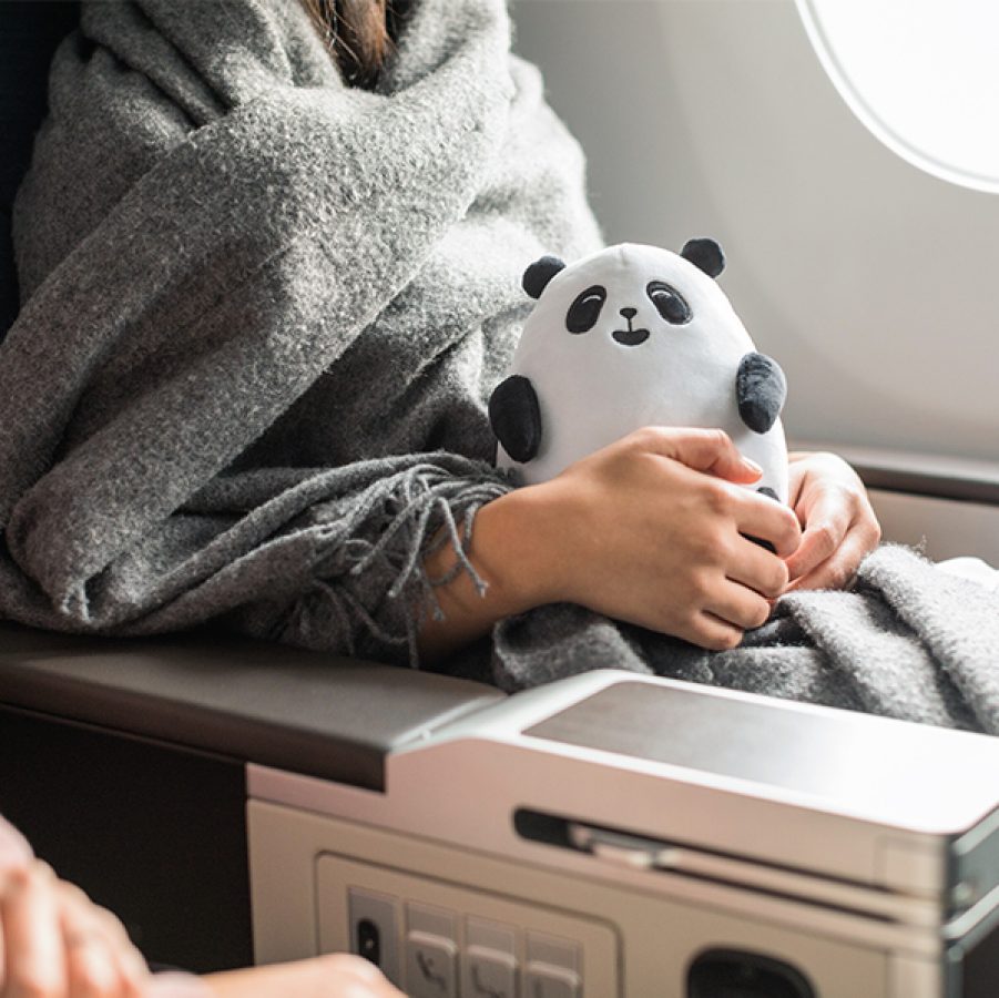Passenger holding Cathay's MIN MIN panda toy