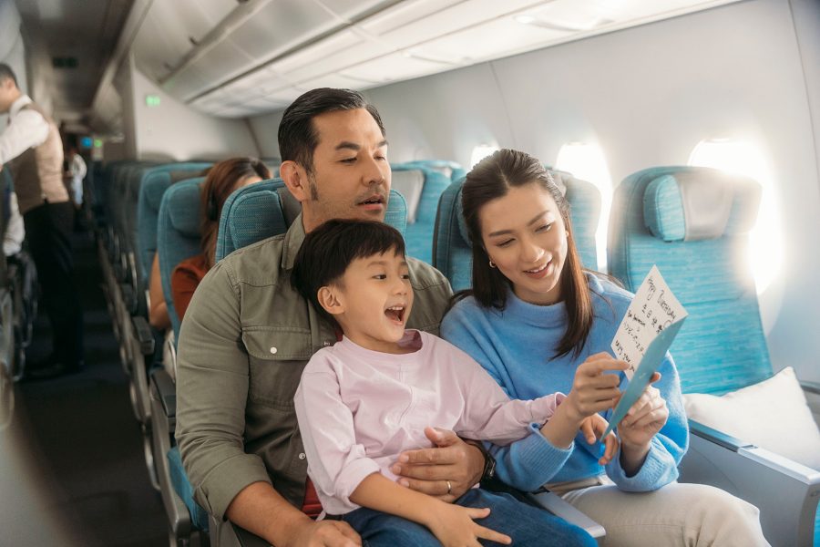 A family looking at leaflet on a plane