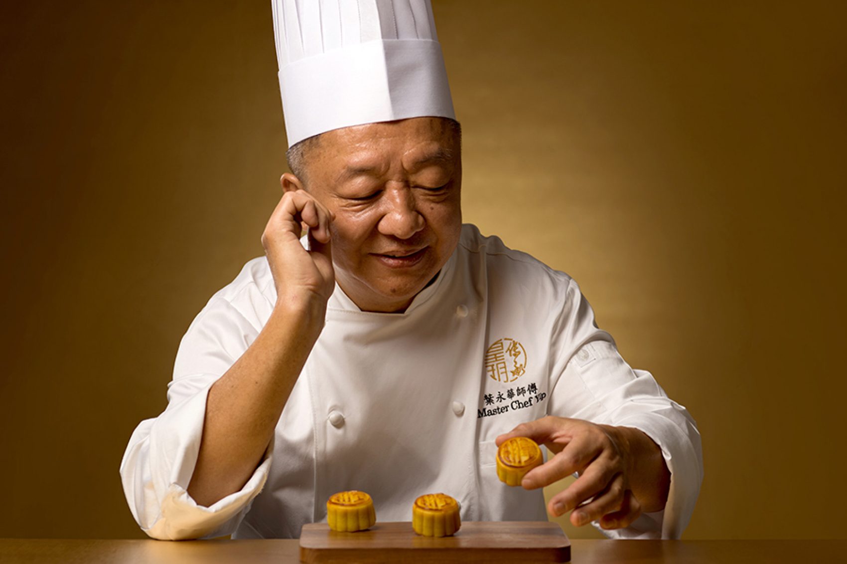 Chef Yip Wing Wah looks at the mooncake in his hand.