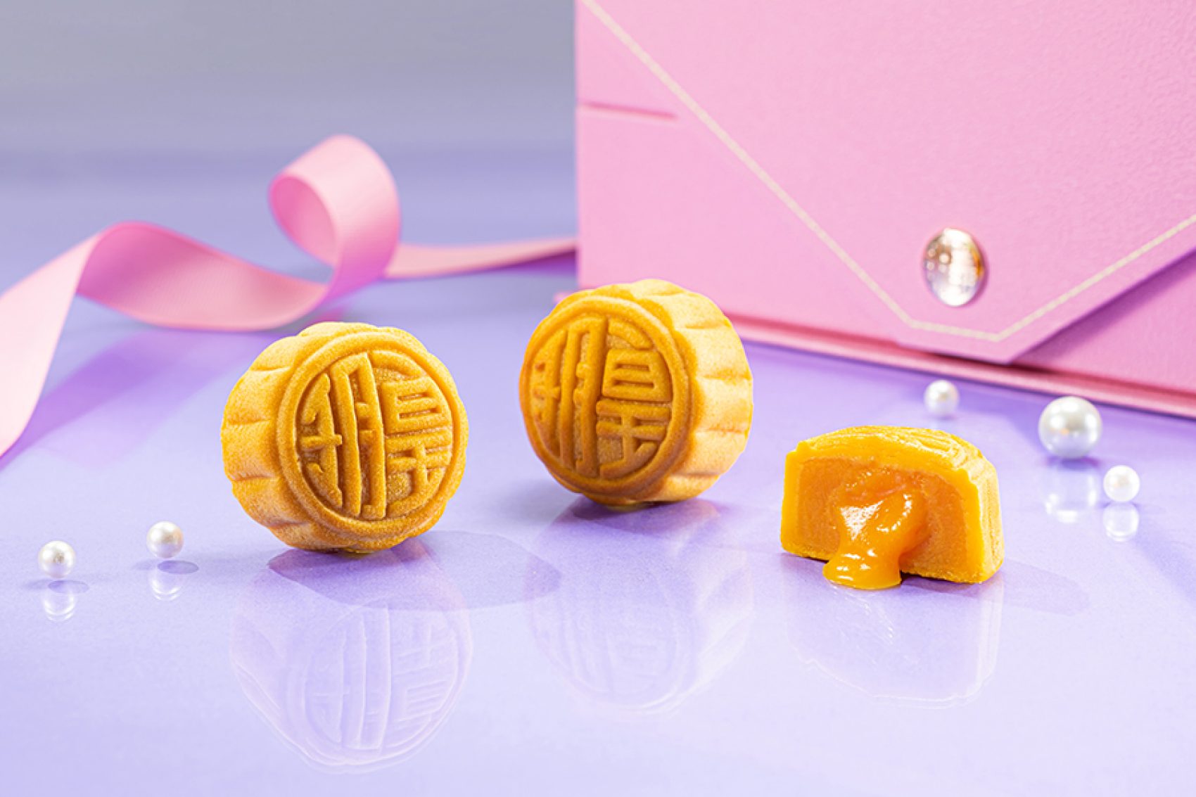 Imperial Patisserie mooncakes in a pink gift box against a purple background.
