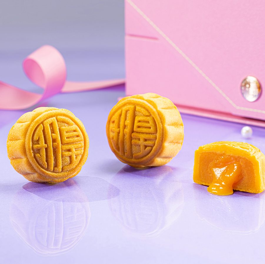 Imperial Patisserie mooncakes in a pink gift box against a purple background.
