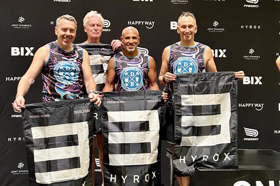 A team of men celebrating competing finishing Hyrox