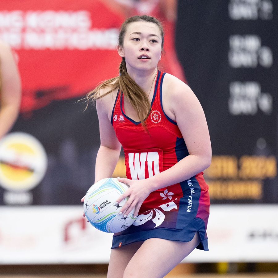 A woman practicing with a volleyball