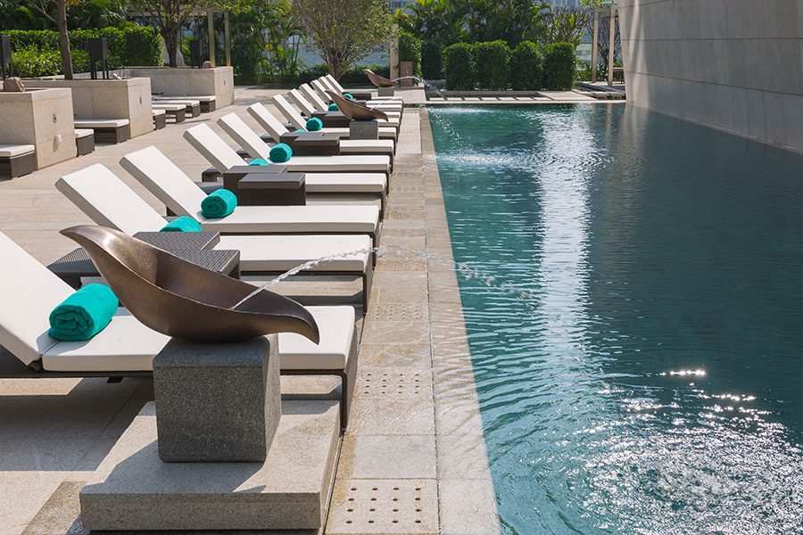 A photo of swimming pool with some beach chairs at Mandarin Oriental Guangzhou