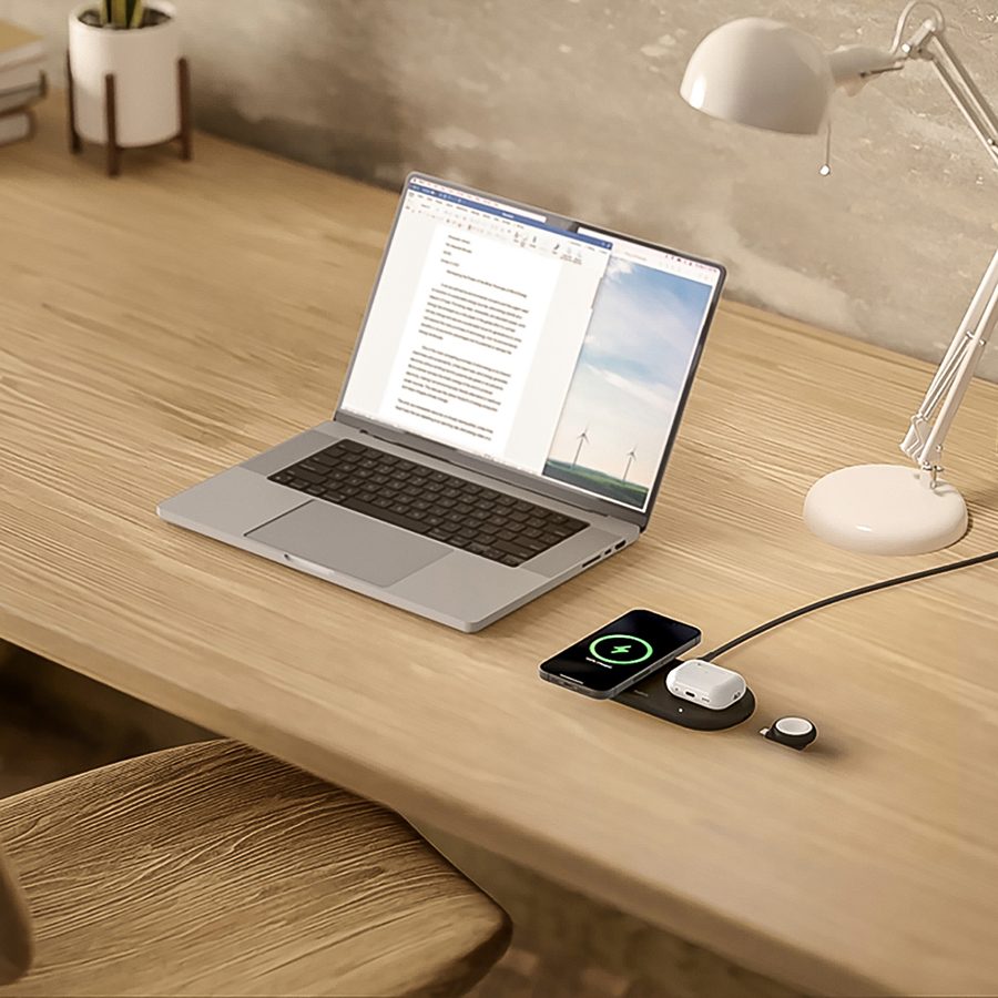 Shot of a desk with a laptop and Belkin magnetic wireless charging pad