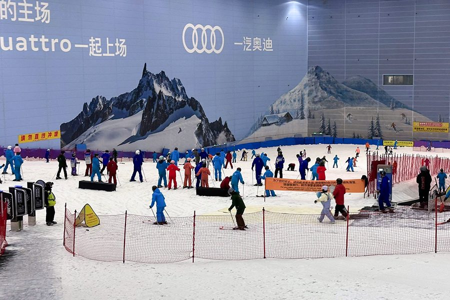 Beginner skiers and snowboarders on a bunny slope at Guangzhou Sunac Snow Park 
