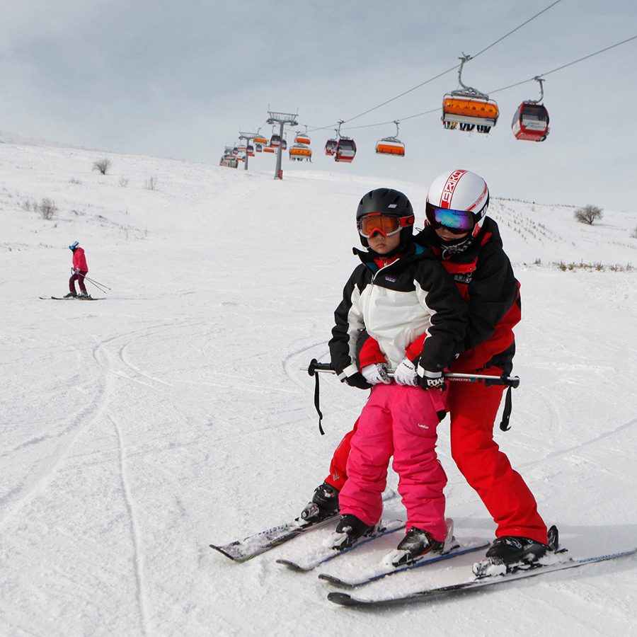  A beginner skier being taught by a ski coach at Yunding Ski Park in Hebei Province 