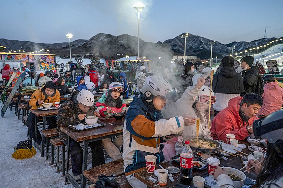 Skiers and snowboarders enjoying an outdoor apres-ski meal at Nanshan Ski Resort, Beijing
