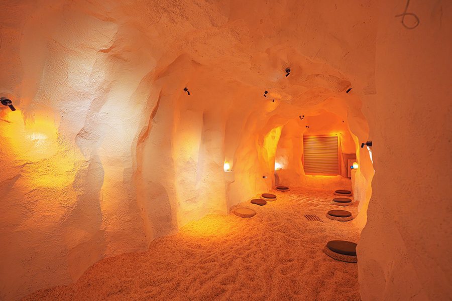 A salt cave in Tangquan Life TENZ with black spotlights and round floor cushions