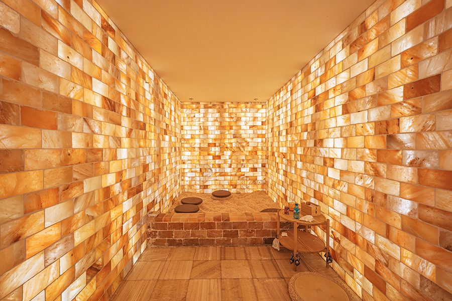 A salt steam room in Tangquan Life TENZ with round floor cushions and a two-tier bar cart