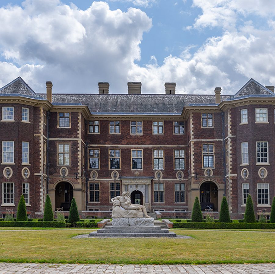 Ham House, a red brick mansion, under blue skies in Richmond-upon-Thames, London. 