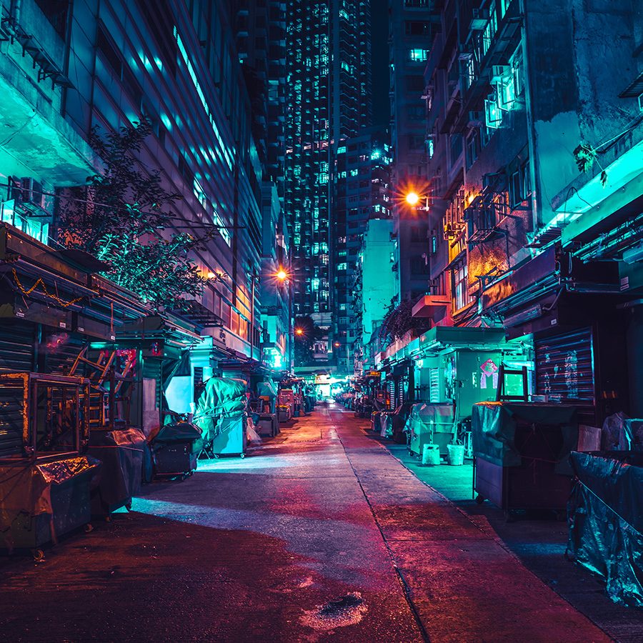 An alleyway in Wan Chai, Hong Kong, illuminated in red and green light at night. 