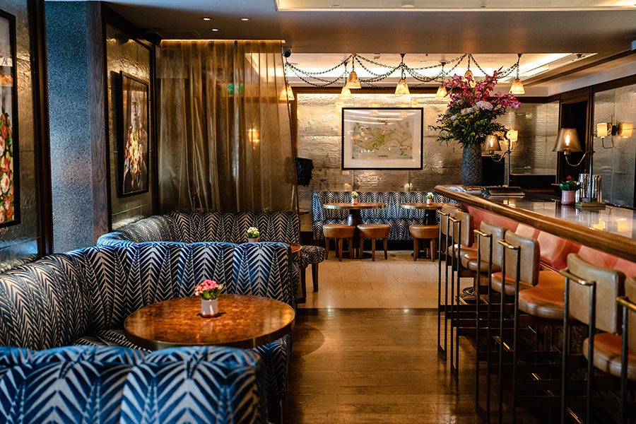 The interior of Corrigan’s Mayfair, London, with banquettes, tables, chairs and a bar