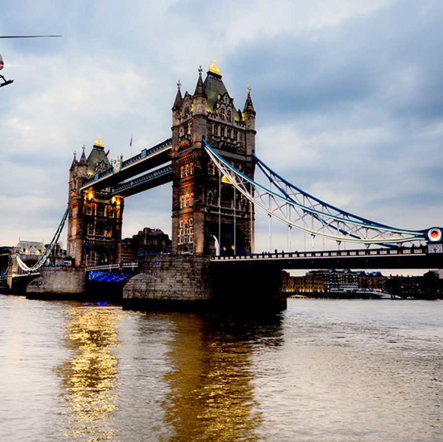 A helicopter flies above London’s Tower Bridge