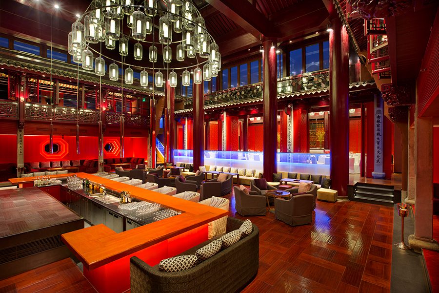 An interior view of Red bar with red interiors and a hanging chandelier at Park Hyatt Ningbo Resort and Spa, China 