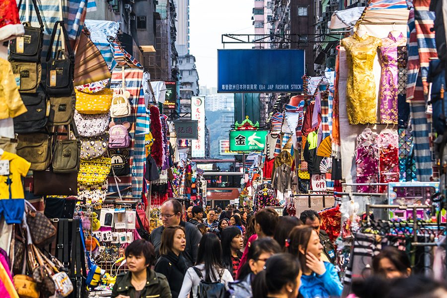 Crowds of people pass stalls selling clothes, bags and other items at the Ladies’ Market (Tung Choi Street), Hong Kong.