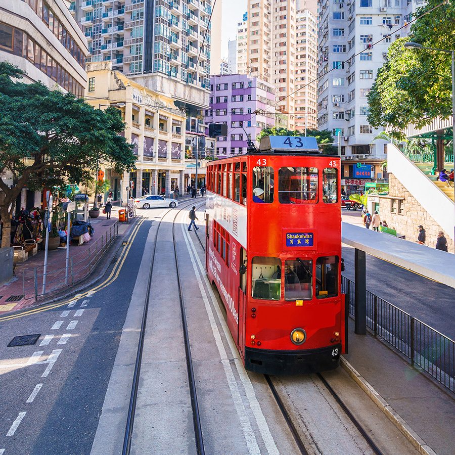 A red tram passing through Wan Chai, Hong Kong. 