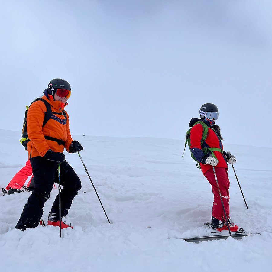 Audrey King and a fellow skier stopped on the side of a ski slope