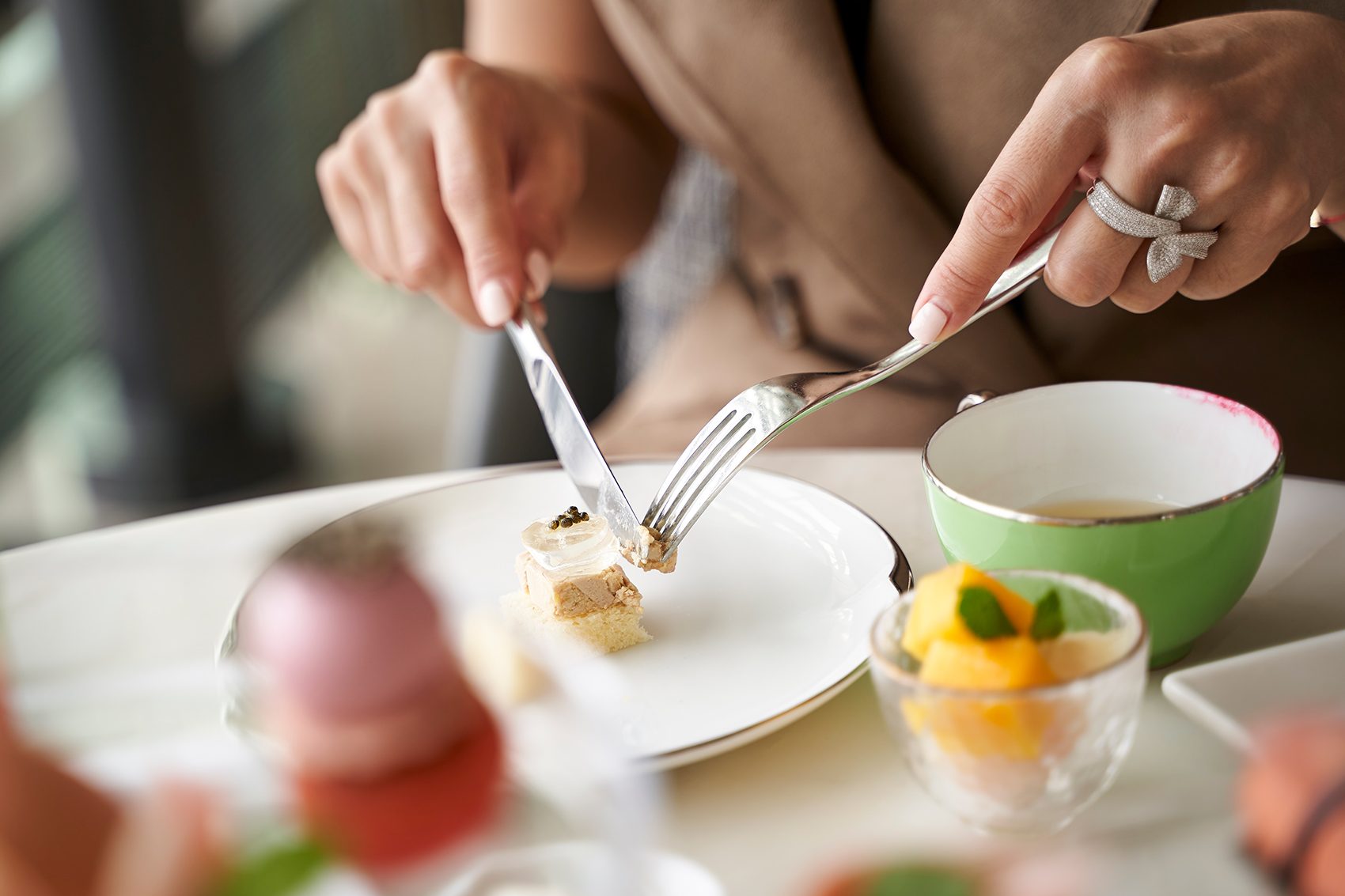 Person using a fork and knife to eat