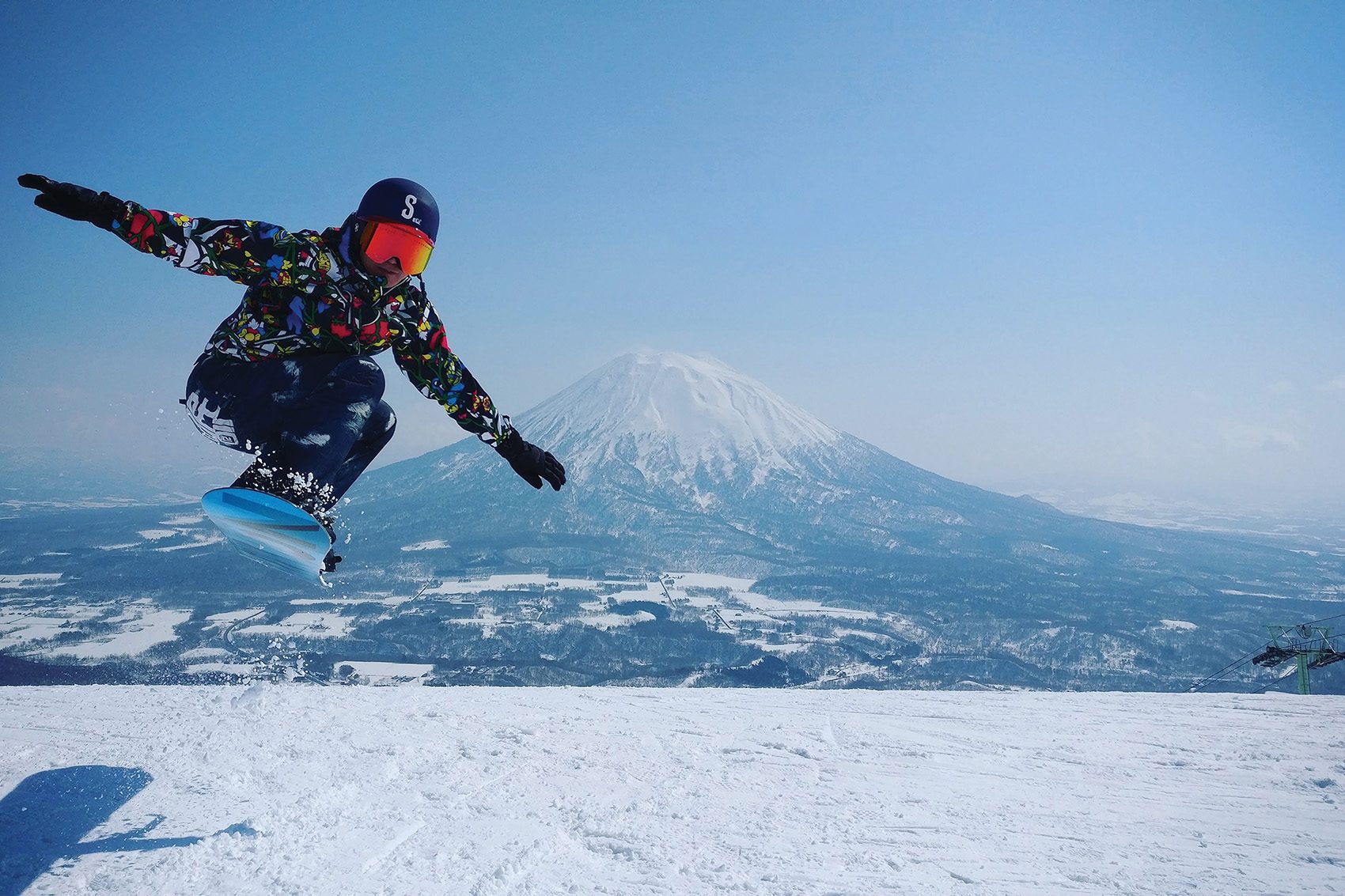 A person jumping on a snowboard in Niseko
