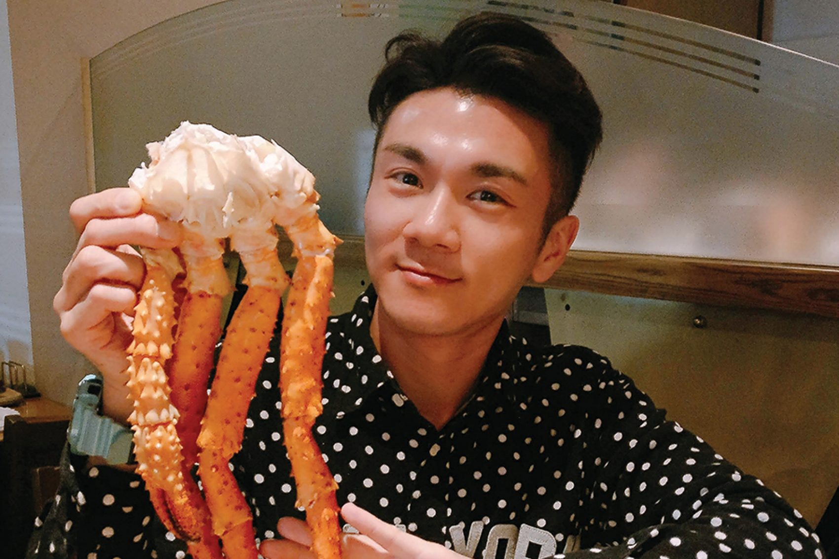 A person holding crab legs