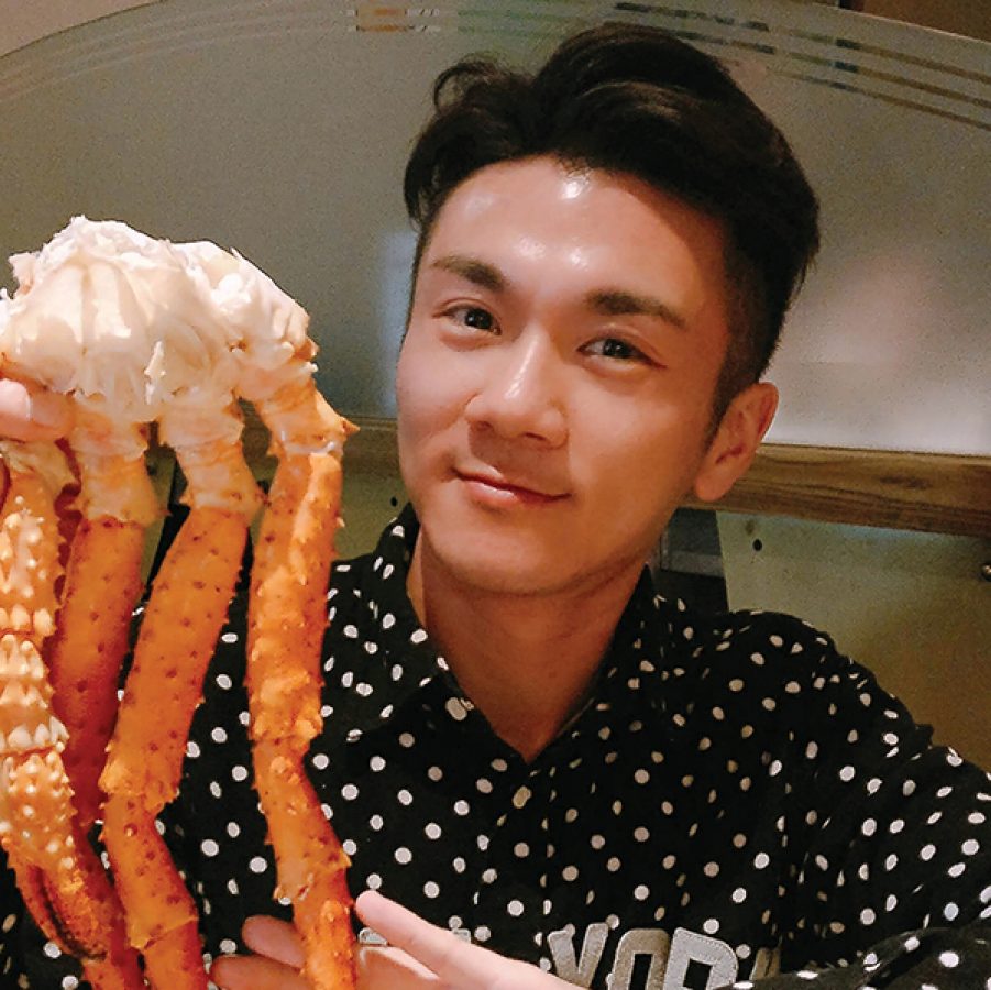 A person holding crab legs