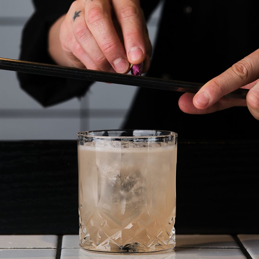 A bartender topping off a drink at Mostly Harmless