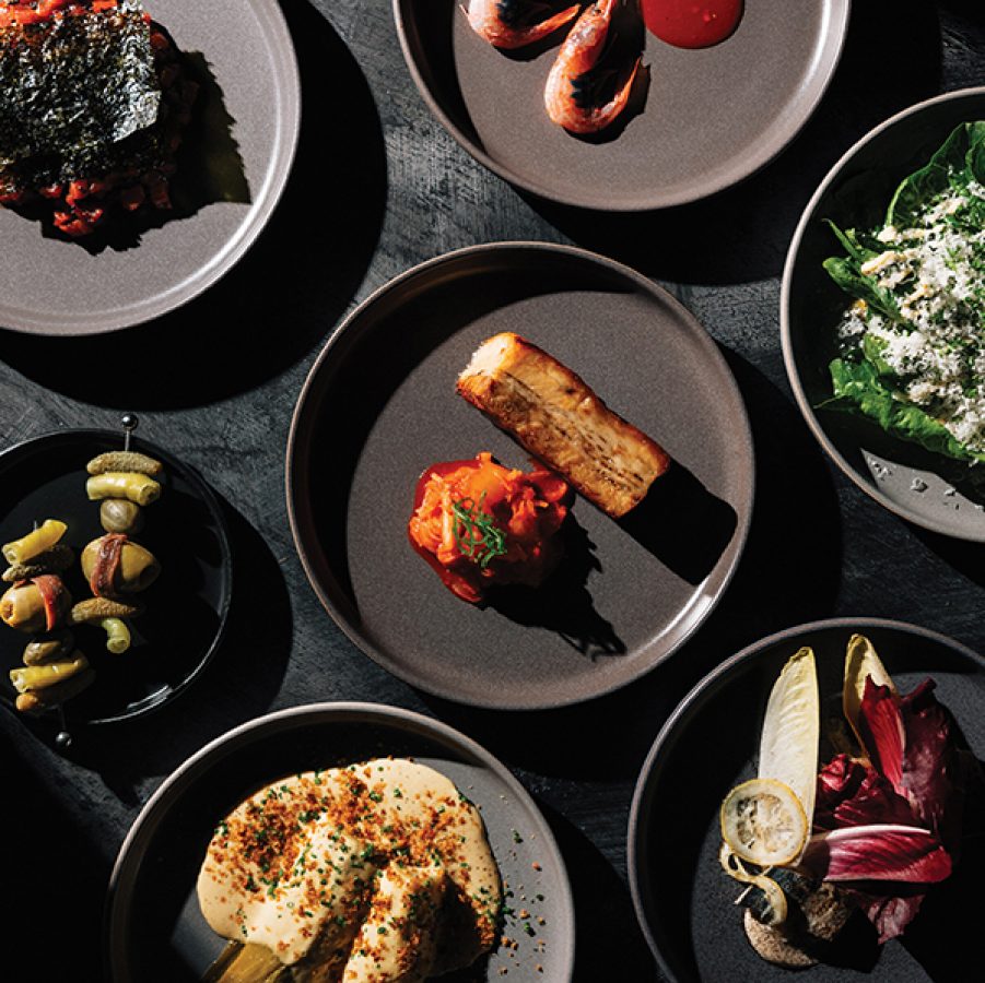 Many plates of food on a dark table at Rabbit, Birmingham