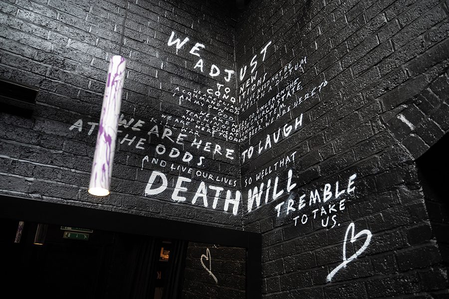 A black brick wall with white writing at The Wilderness, Birmingham