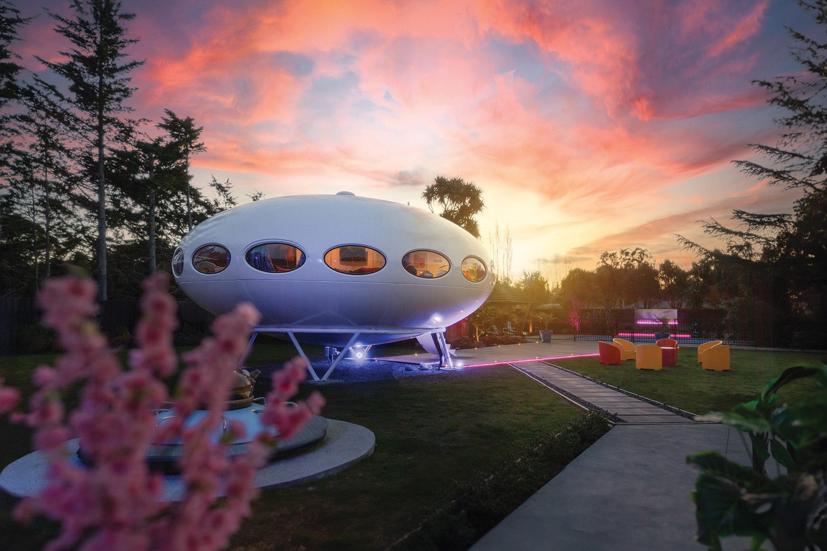 External view of a Futuro House against a sunset