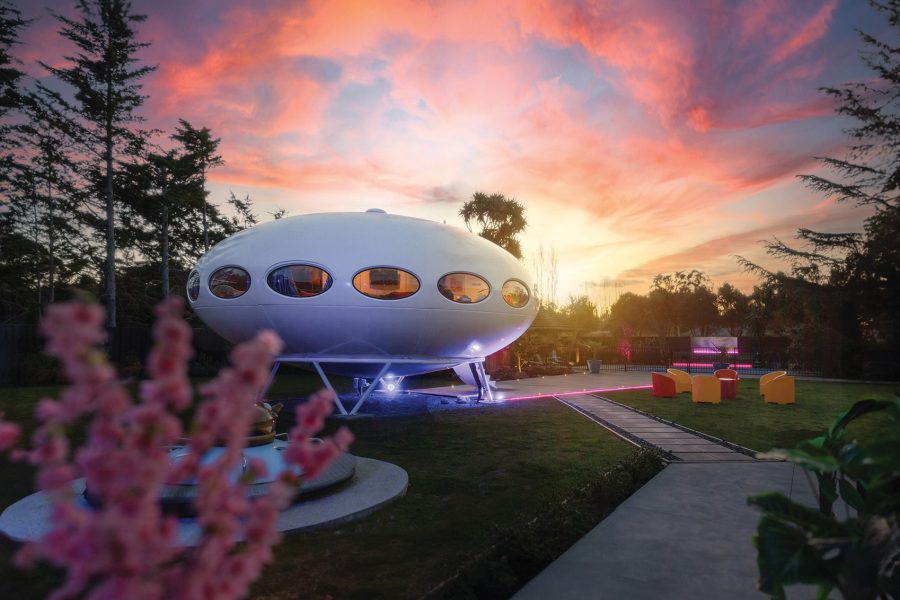 External view of a Futuro House against a sunset