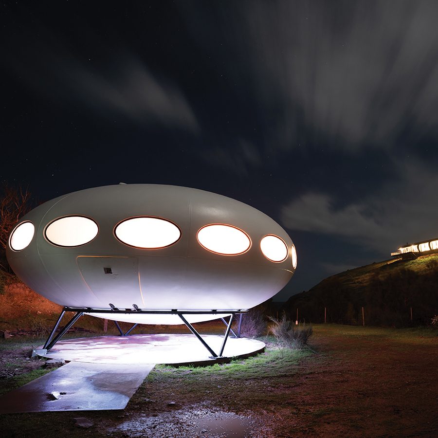 External view of a Futuro House with lights turned on 
