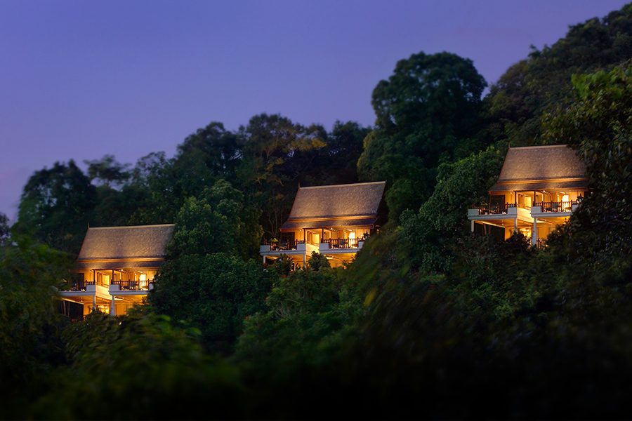 Three hilltop villas lit up at dusk at Pangkor Laut Resort, Malaysia