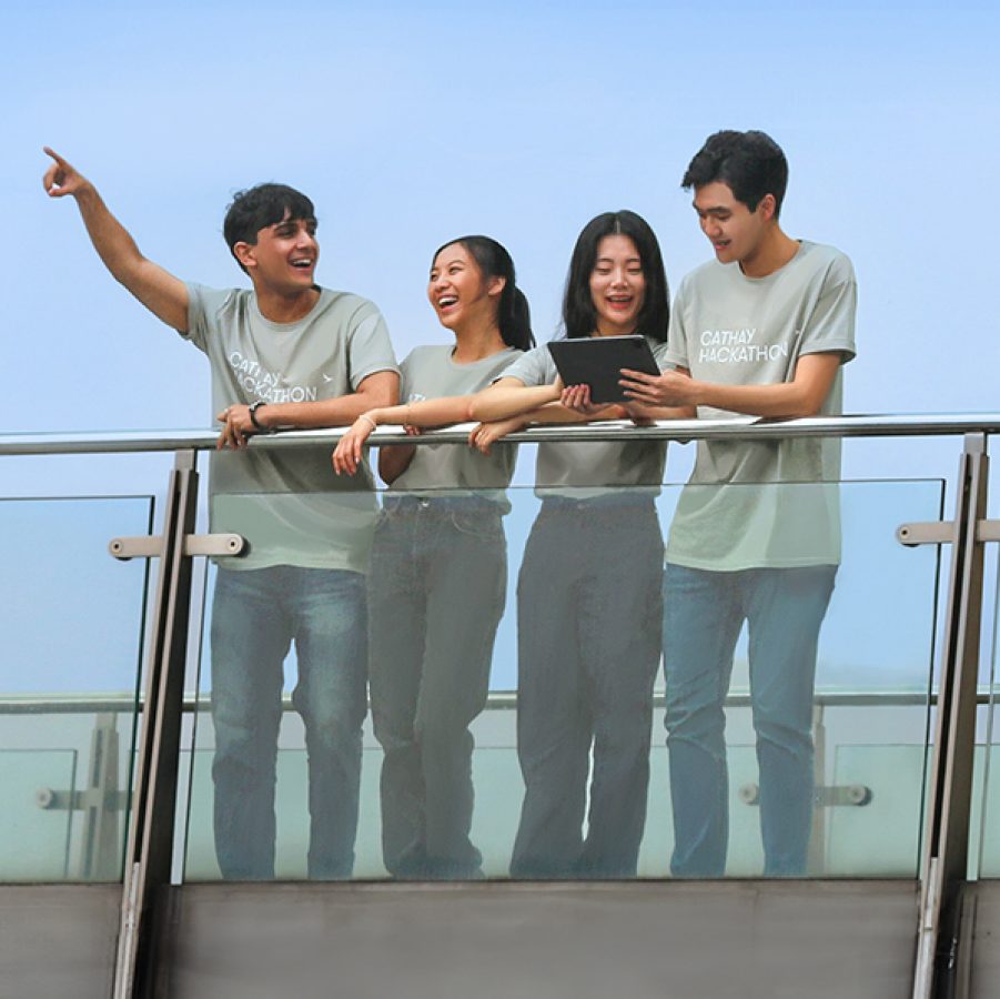 A Cathay Hackathon team standing and chatting outdoors