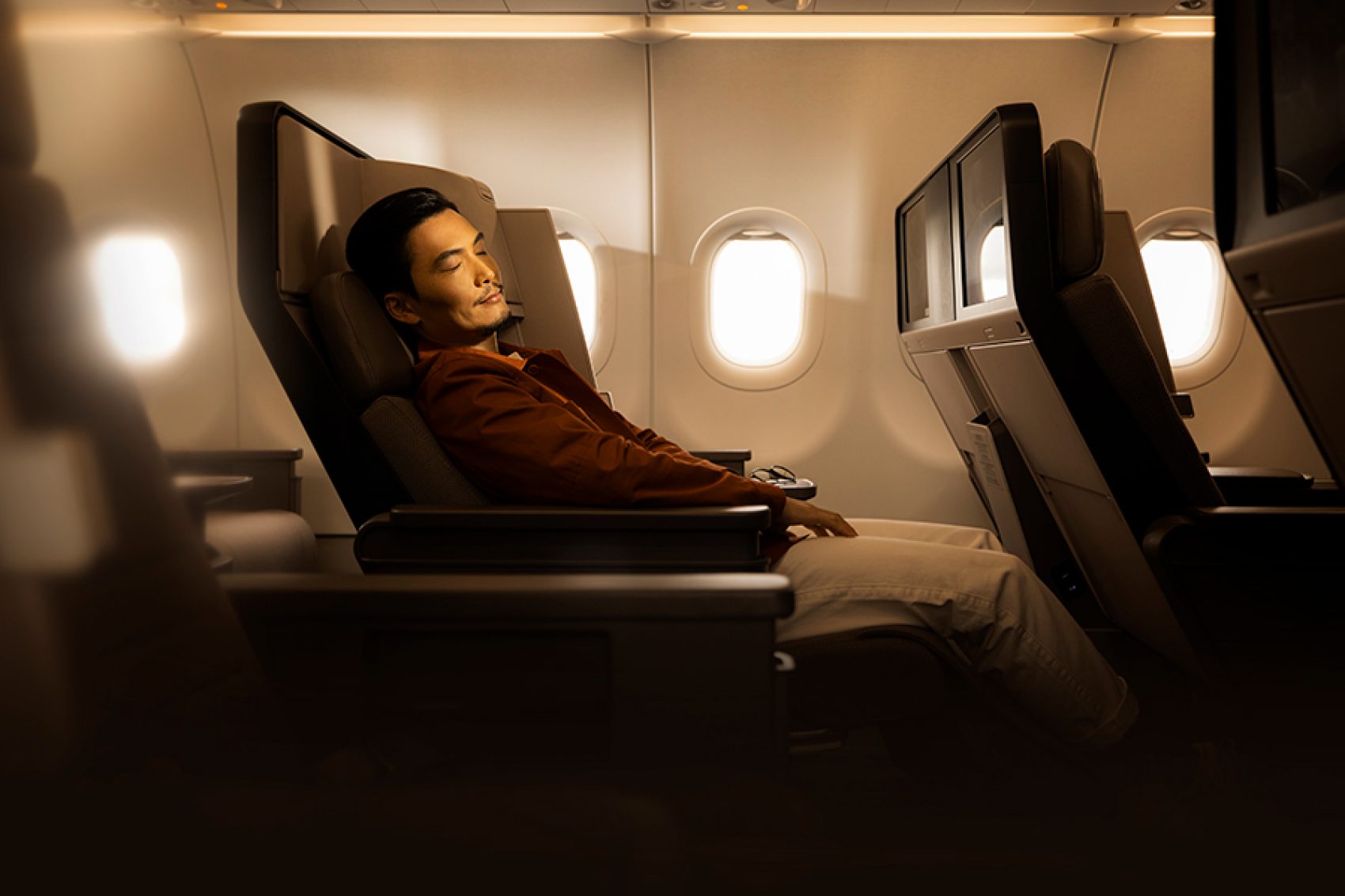 A man sleeping on an aeroplane. 