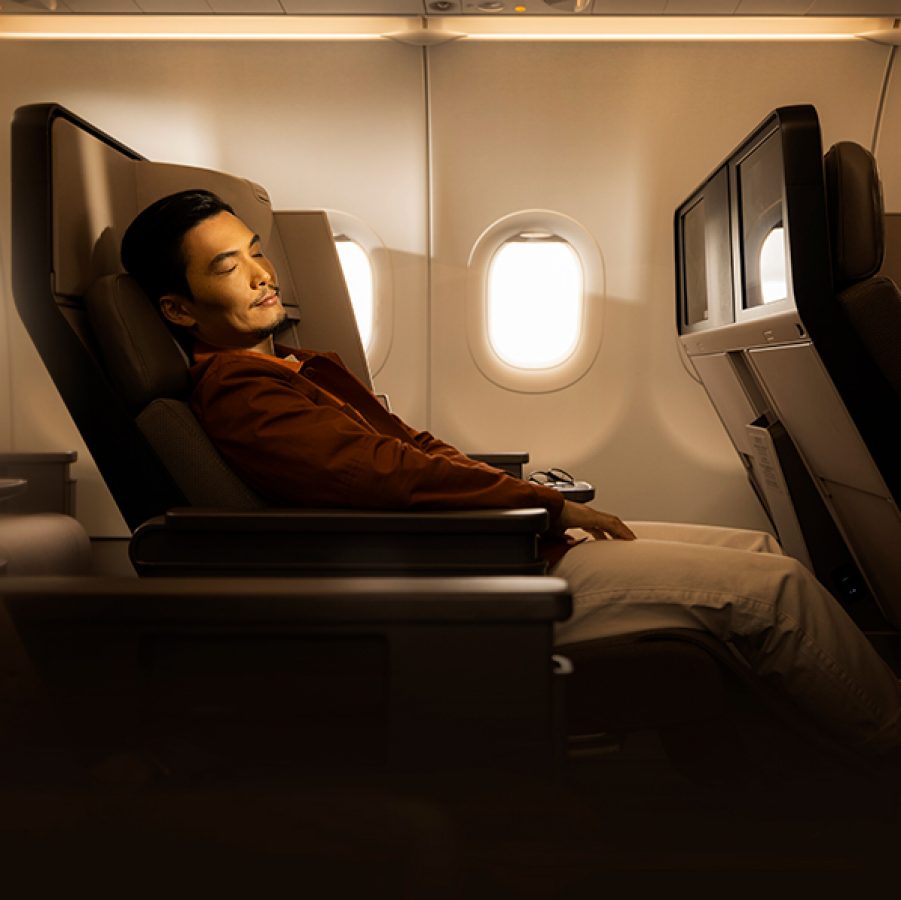 A man sleeping on an aeroplane. 
