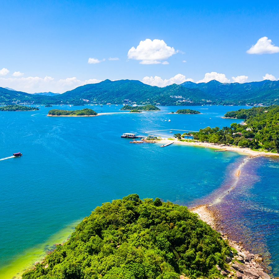 Aerial view of the tombolo connecting Sharp Island to Kiu Tau Chau in Hong Kong in the daytime.