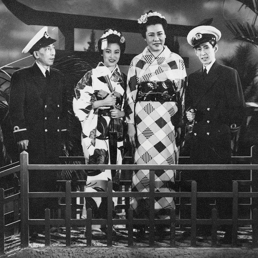 A film still of Madam Butterfly, showing two sailors and two women in kimono