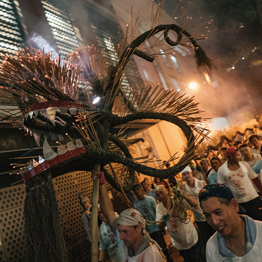Performers of the Tai Hang Fire Dance holding up the dragon