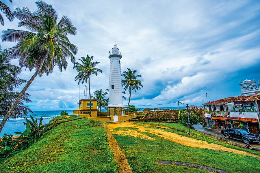 A lighthouse on a grassy hill in Sri Lanka