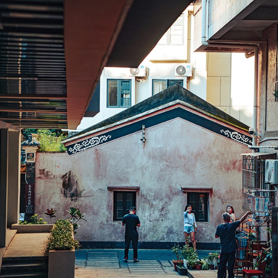 A street view of people standing on Chunjing Street during daytime inside Nantou Ancient City