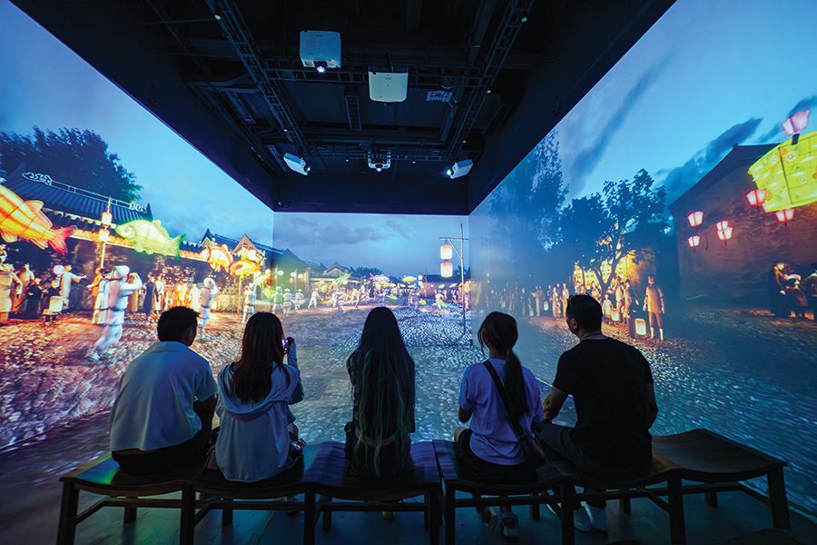 A group of men and women watching a multimedia video exhibition at the Nantou 1820 Digital Exhibition Hall