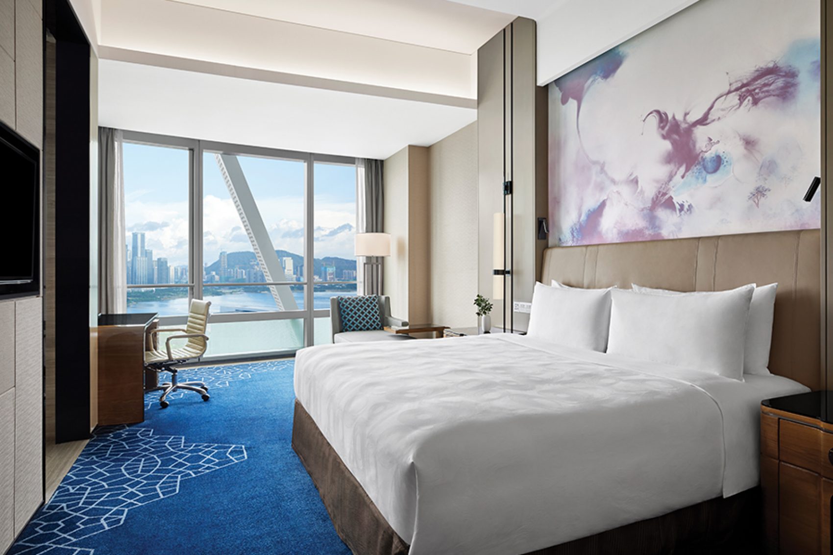 An interior view of JW Marriot Hotel Shenzhen Bao’an guestroom with views of Qianhai Bay during daytime