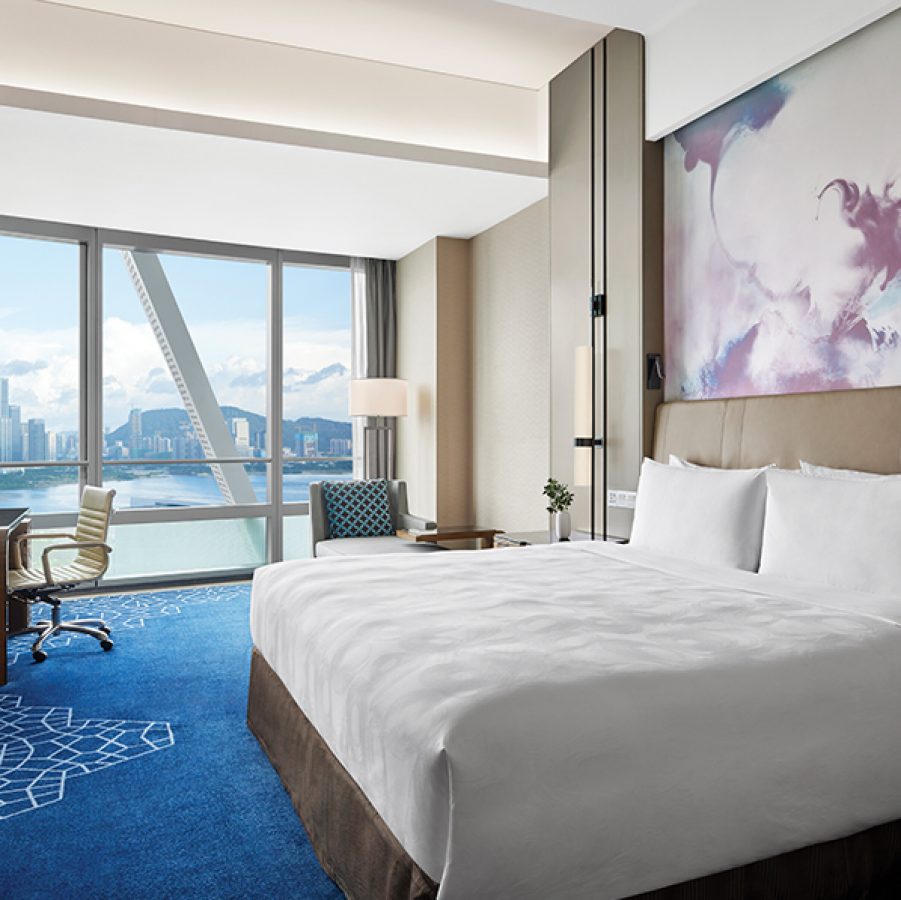 An interior view of JW Marriot Hotel Shenzhen Bao’an guestroom with views of Qianhai Bay during daytime