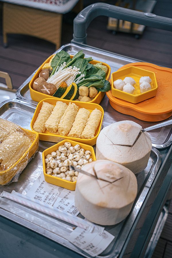 Accompanying dishes for coconut chicken hotpot at Season, including veggies, mushrooms, fishballs and beancurd rolls 