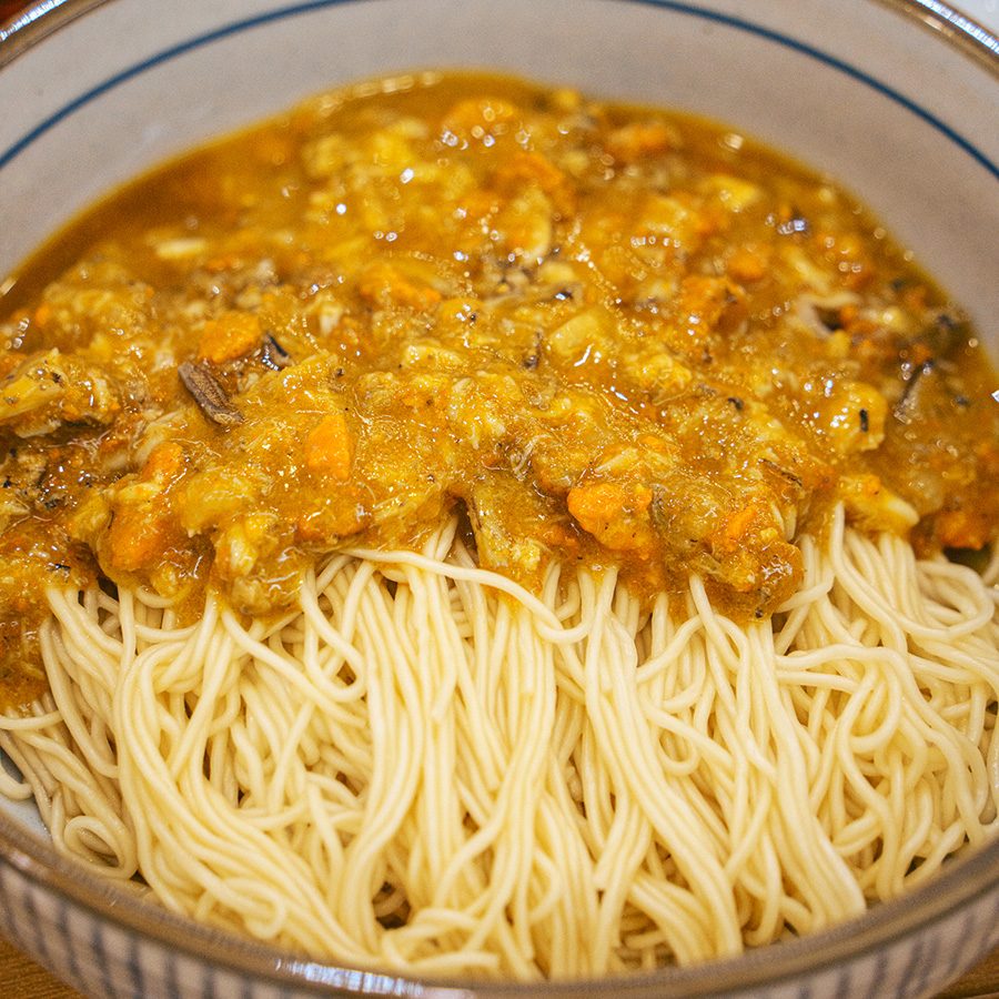 Crab roe and crab meat sauce over noodles at Xie San Bao in Shenzhen
