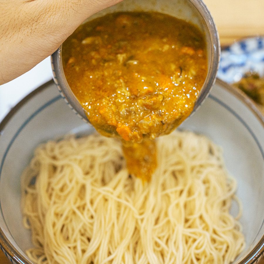 Crab roe and crab meat sauce poured over noodles at Xie San Bao in Nanshan, Shenzhen