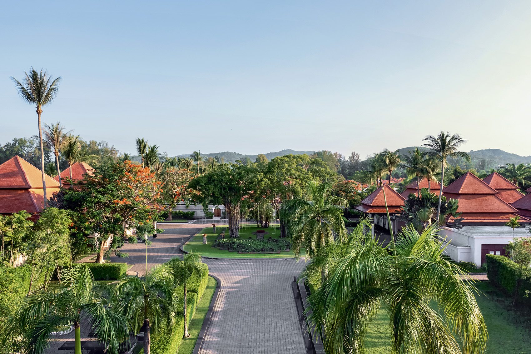 A wide view of Thai-style bungalows and palm trees at Banyan Tree Phuket