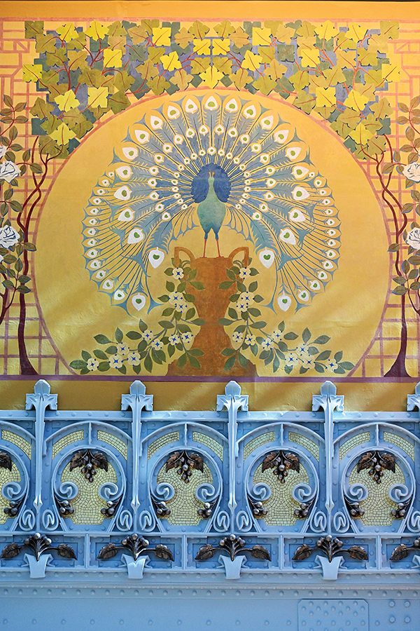 A mural depicting a peacock near the ceiling of the inside of La Samaraitaine, a large department store