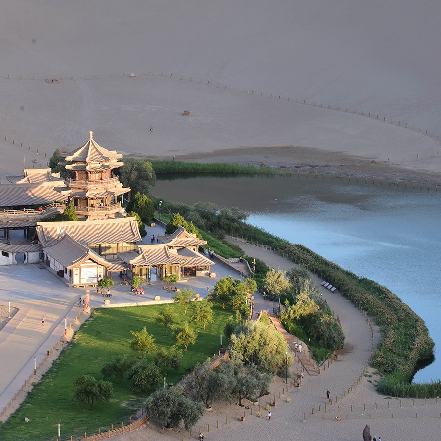 Crescent Lake with a pagoda to the left and sand dunes all around